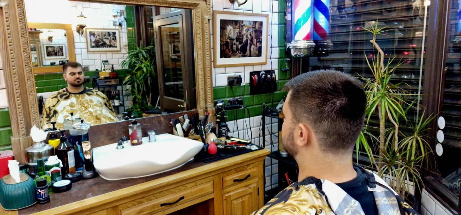 The wood-panelled shop seen in the mirror, sink and product shelf along the wall